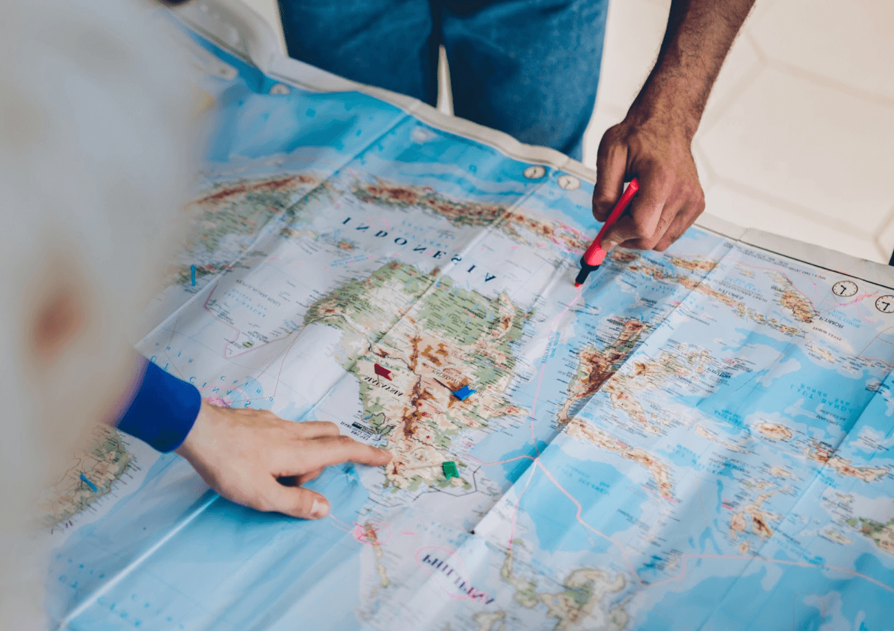 two people looking over map of Indonesia